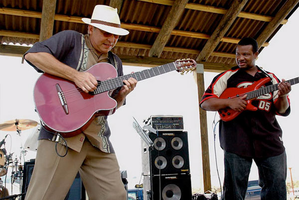 Entertainer on stage at the winery playing guitar.