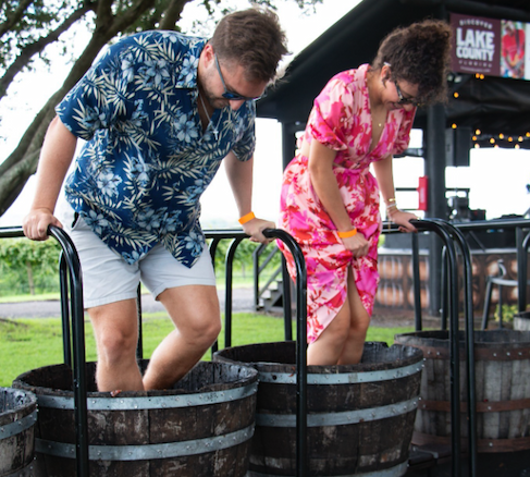 Man and woman stomping grapes.