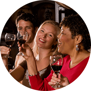 Mixed group of men and women enjoying a glass of wine.